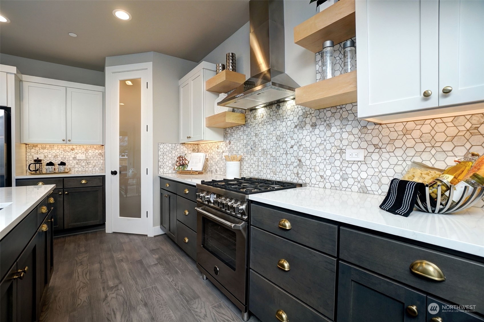 18146 94th Avenue Northeast Bothell, WA 98011 - Photo 8 of 37 a kitchen with stainless steel appliances granite countertop a stove a sink dishwasher and cabinets with wooden floor