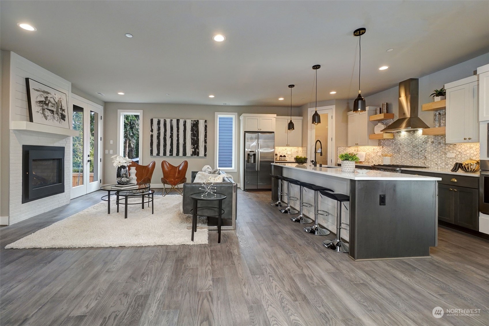 18146 94th Avenue Northeast Bothell, WA 98011 - Photo 9 of 37 a kitchen with stainless steel appliances kitchen island granite countertop a stove a sink a dining table and chairs