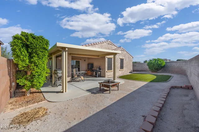 a view of a house with swimming pool and sitting area