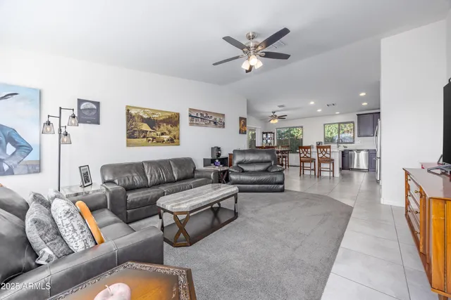 a living room with furniture and view of kitchen