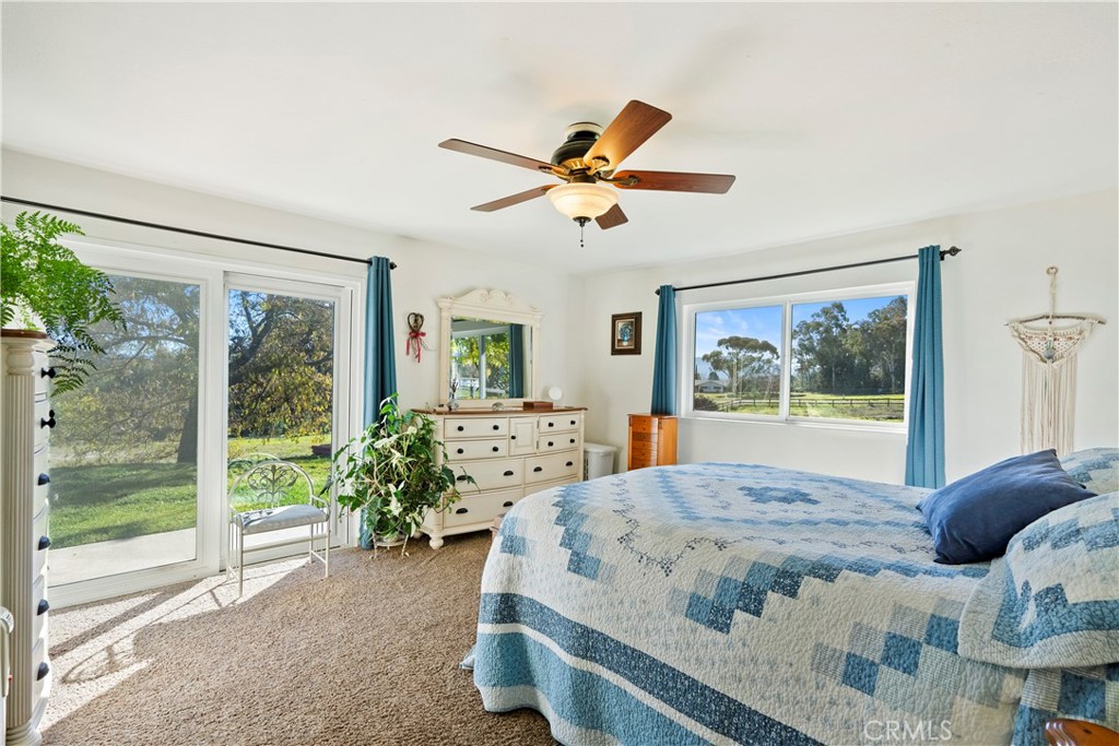 9220 Carmel Road Atascadero, CA 93422 - Photo 22 of 61 The primary bedroom is a lovely space with a sliding glass door that brings the outside in.