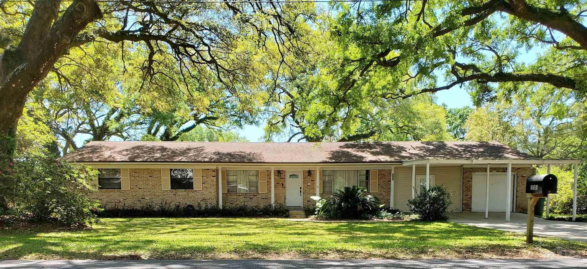 233 Cherokee Trail Pensacola, FL 32506 - Photo 1 of 36 a front view of a house with garden