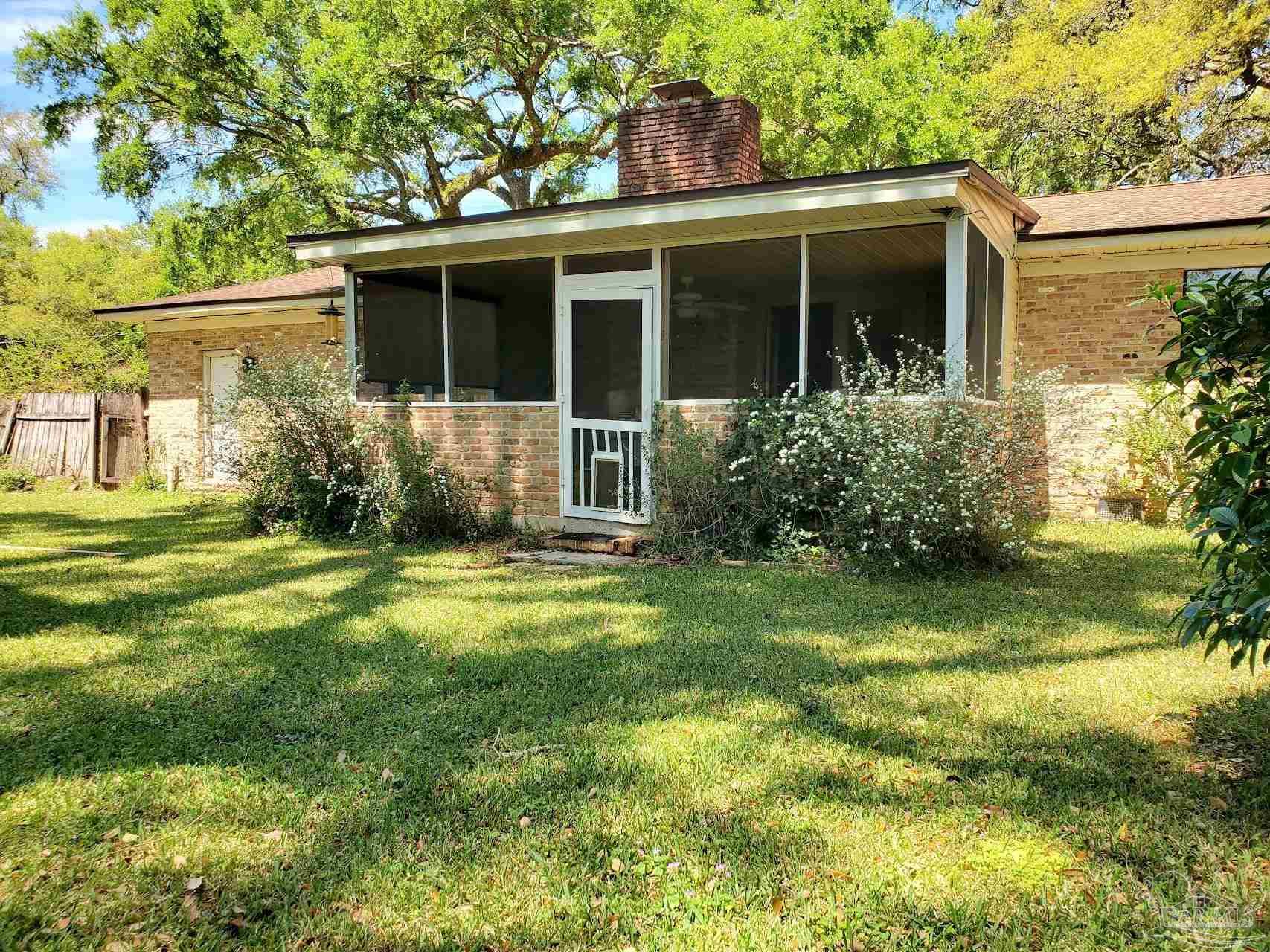 233 Cherokee Trail Pensacola, FL 32506 - Photo 18 of 36 a front view of a house with garden