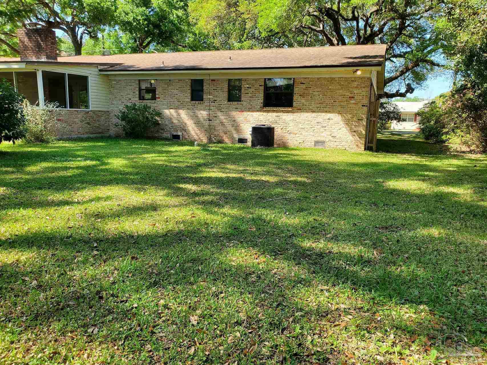 233 Cherokee Trail Pensacola, FL 32506 - Photo 20 of 36 a front view of house with yard and green space