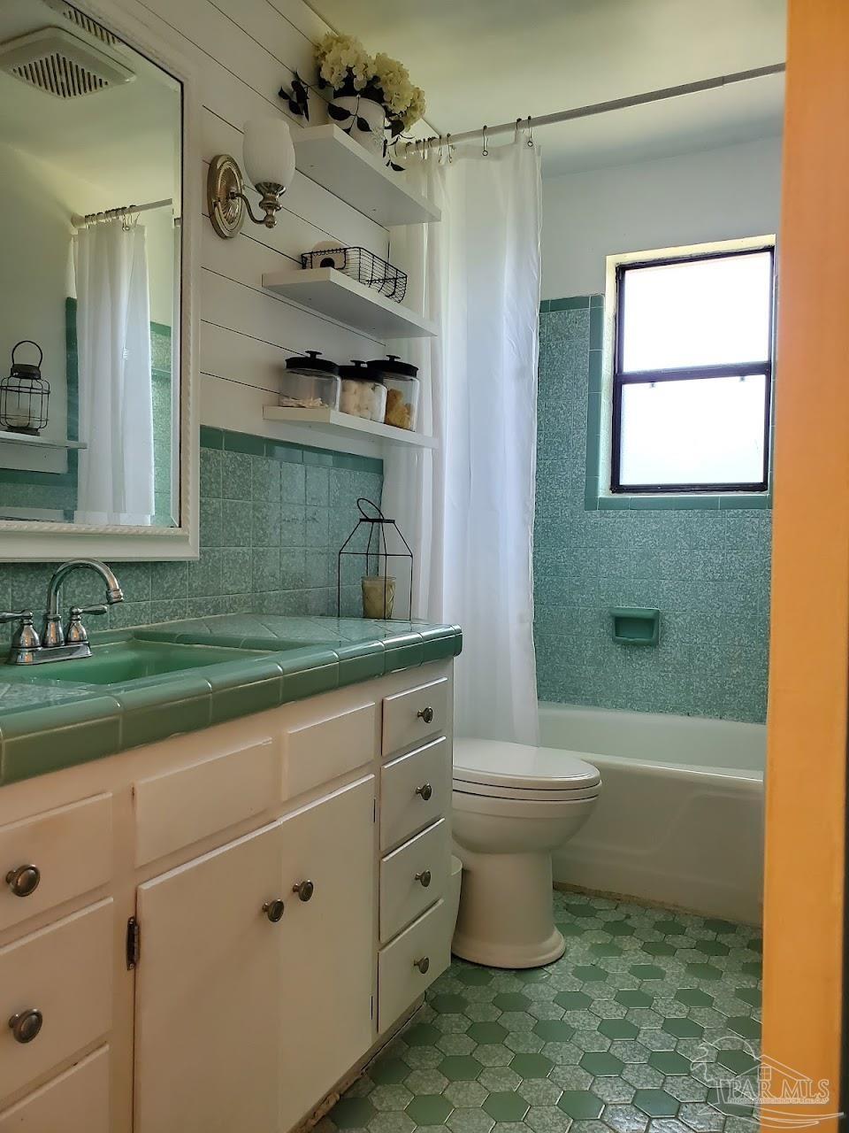 233 Cherokee Trail Pensacola, FL 32506 - Photo 22 of 36 a bathroom with a sink a toilet and shower