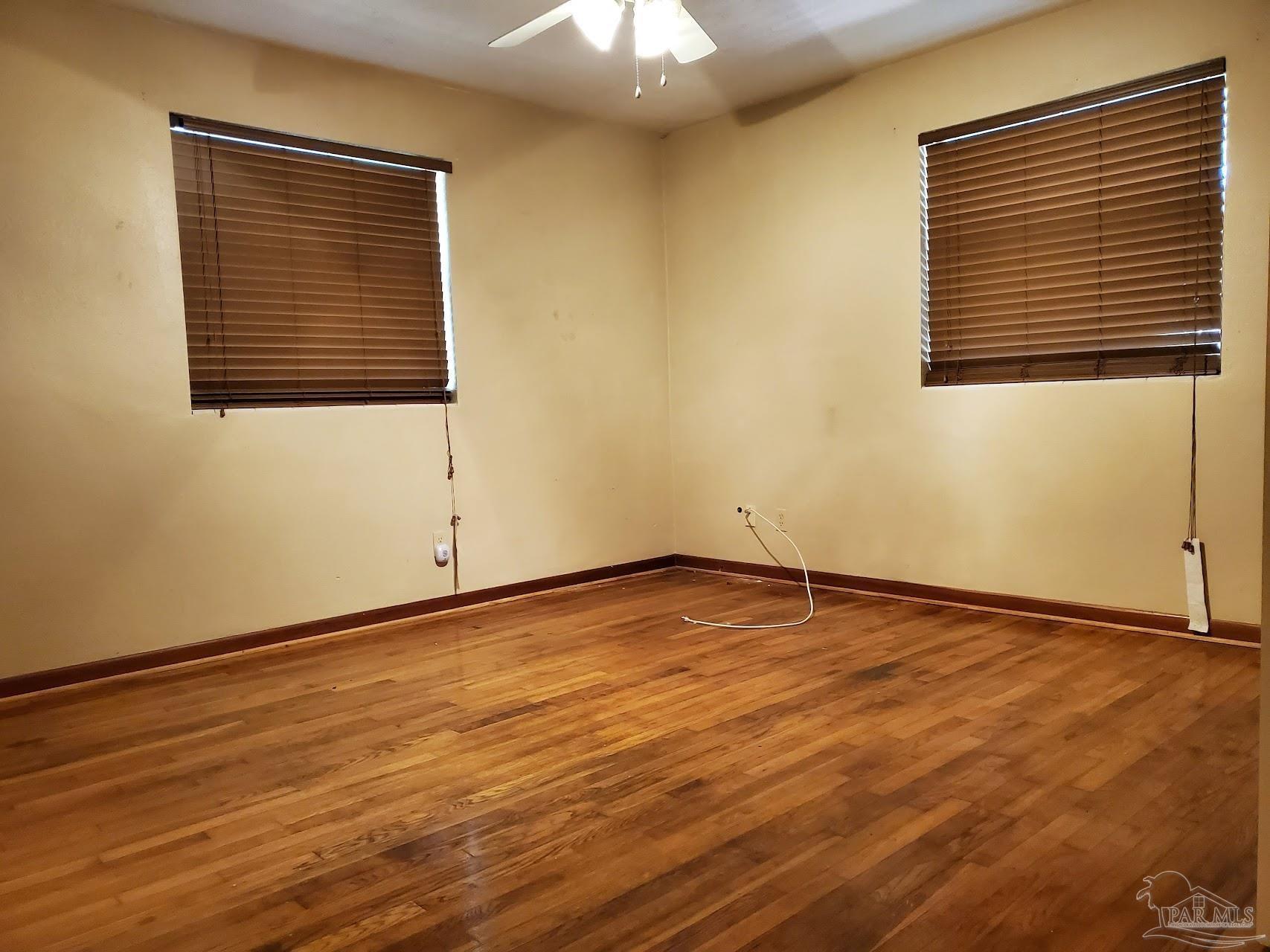 233 Cherokee Trail Pensacola, FL 32506 - Photo 30 of 36 a view of an empty room with wooden floor and a window