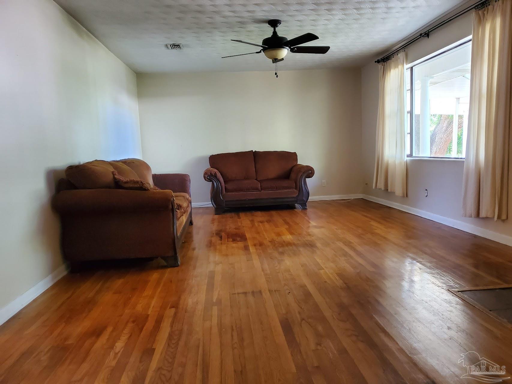 233 Cherokee Trail Pensacola, FL 32506 - Photo 3 of 36 a living room with couch and a ceiling fan