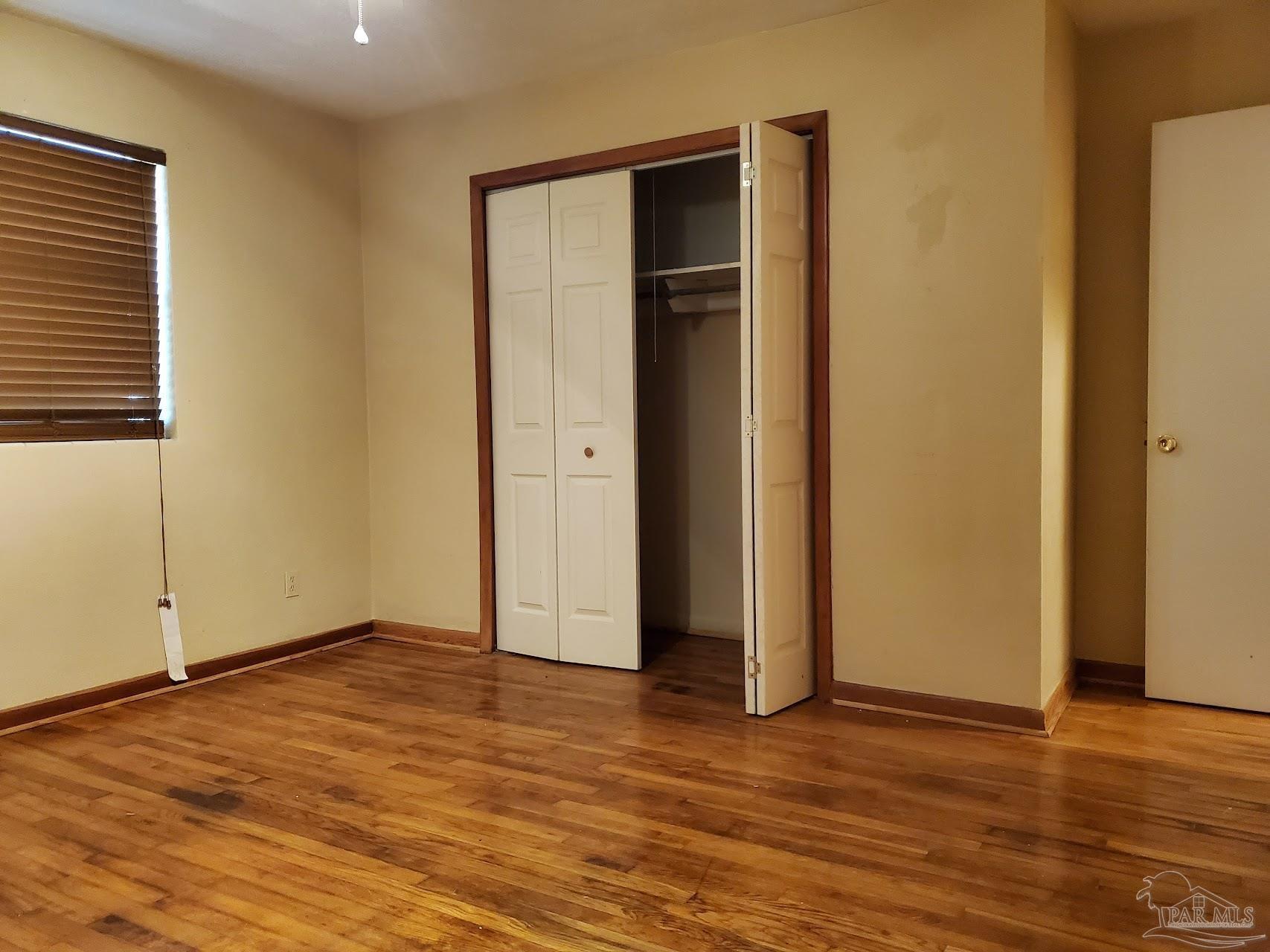 233 Cherokee Trail Pensacola, FL 32506 - Photo 32 of 36 a view of an empty room with wooden floor and closet