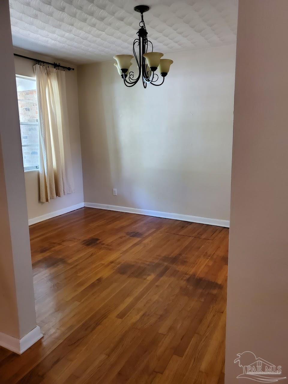 233 Cherokee Trail Pensacola, FL 32506 - Photo 5 of 36 a view of empty room with wooden floor and window