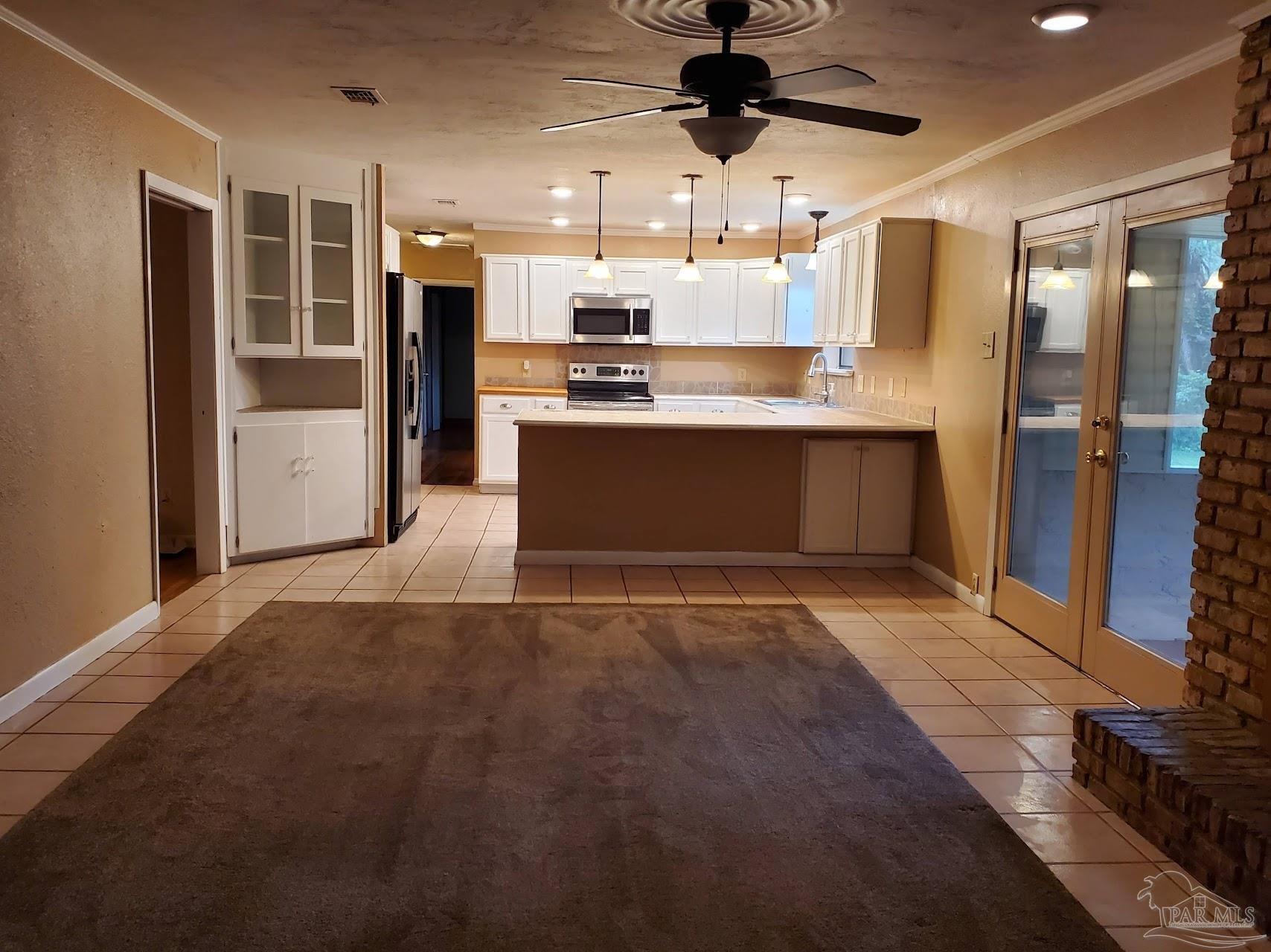 233 Cherokee Trail Pensacola, FL 32506 - Photo 10 of 36 a kitchen with stainless steel appliances kitchen island granite countertop a refrigerator and a sink