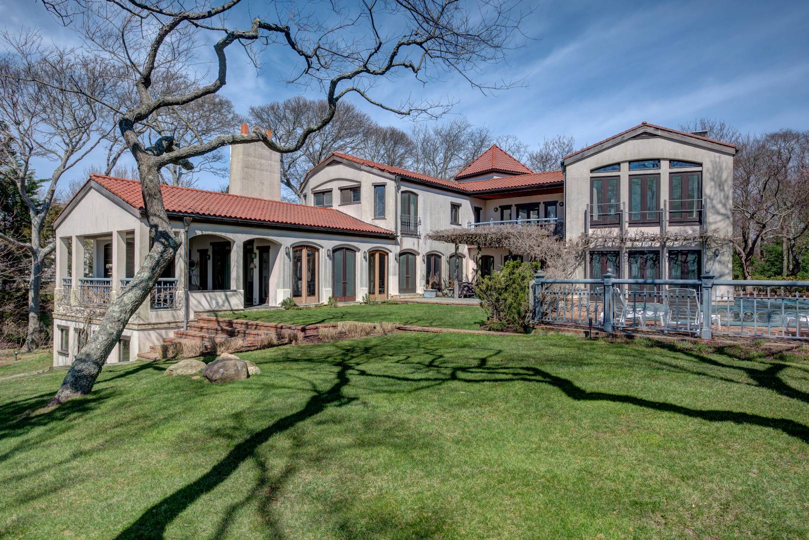 46 On The Bluff Sag Harbor, NY 11963 - Photo 18 of 19 a view of a big house with a big yard and large trees