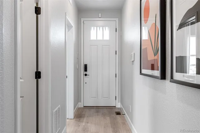 a living room with fireplace furniture and a large window