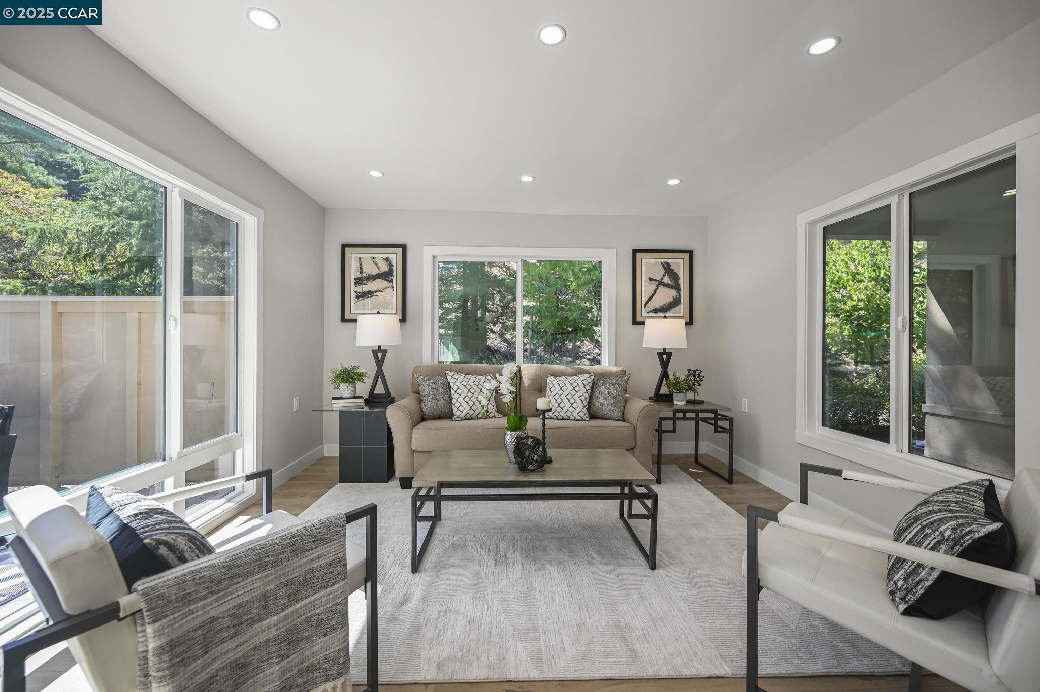 a living room with furniture and a large window