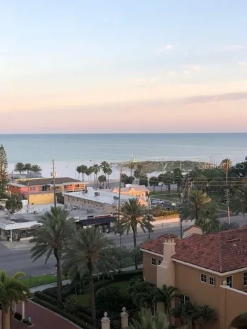 a front view of an apartment with a garden and plants