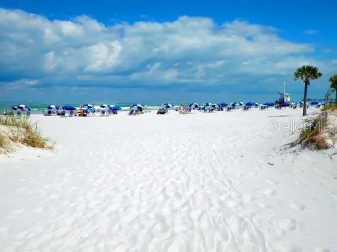 a view of a house with swimming pool and sitting area