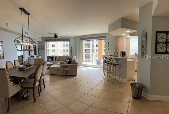 a kitchen with kitchen island granite countertop a stove cabinets and chairs