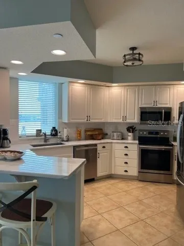 a kitchen with a sink window and cabinets