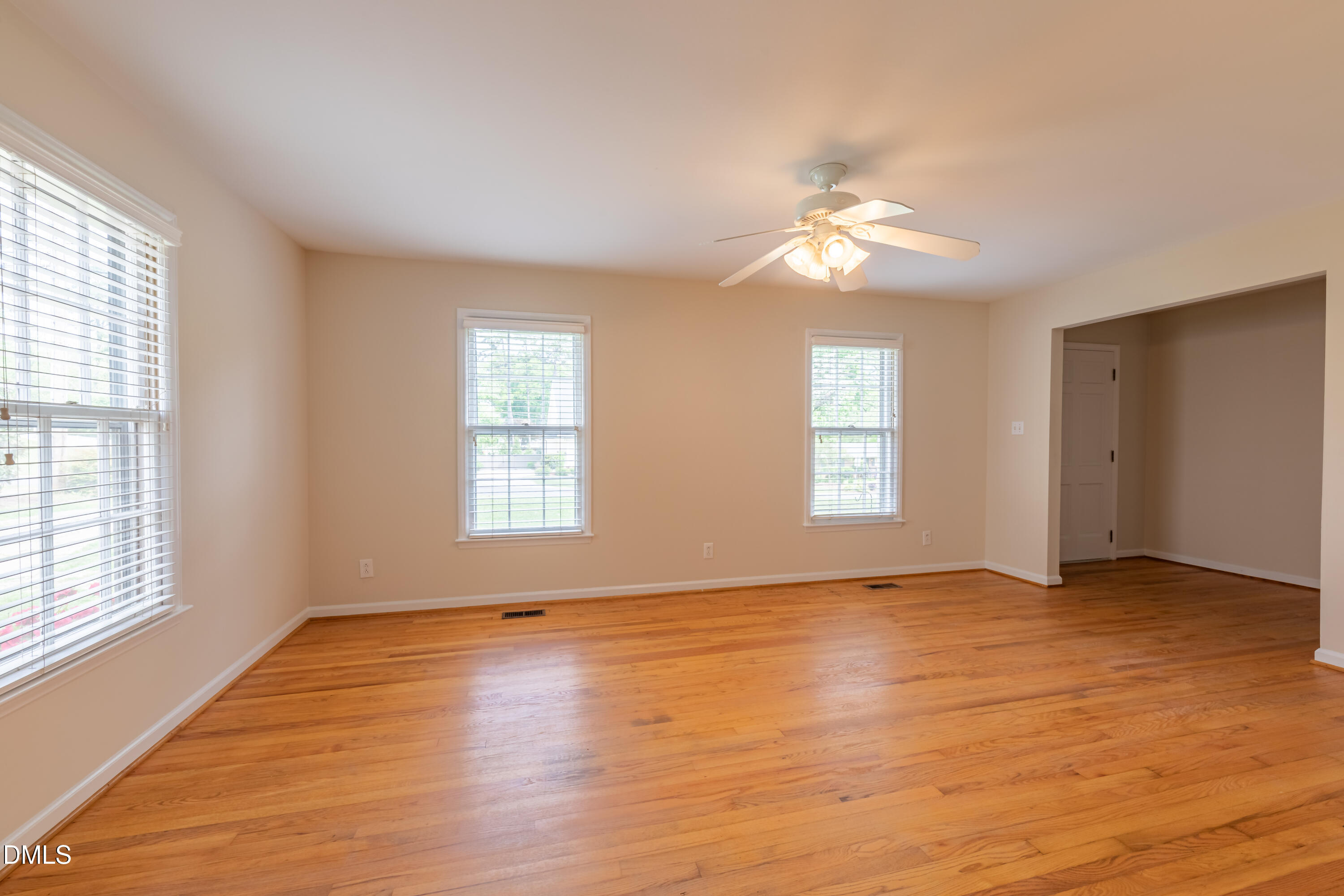 408 Ortega Road Raleigh, NC 27609 - Photo 3 of 25 a view of empty room with wooden floor and fan
