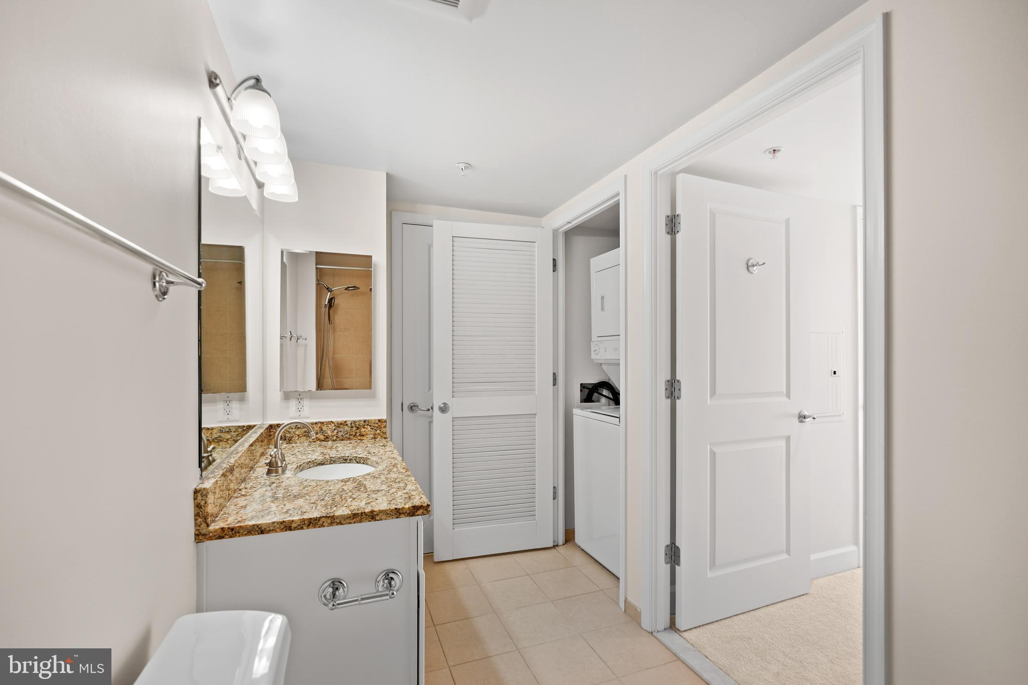 11800 Sunset Hills Road, Unit 611 Reston, VA 20190 - Photo 19 of 40 a bathroom with a granite countertop sink and a mirror