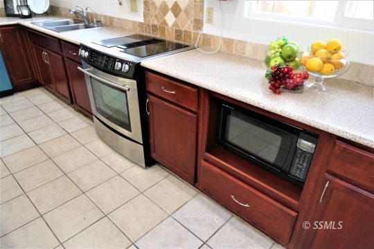 337 Larkspur Street Ridgecrest, CA 93555 - Photo 15 of 38 a kitchen with stainless steel appliances a sink dishwasher and cabinets