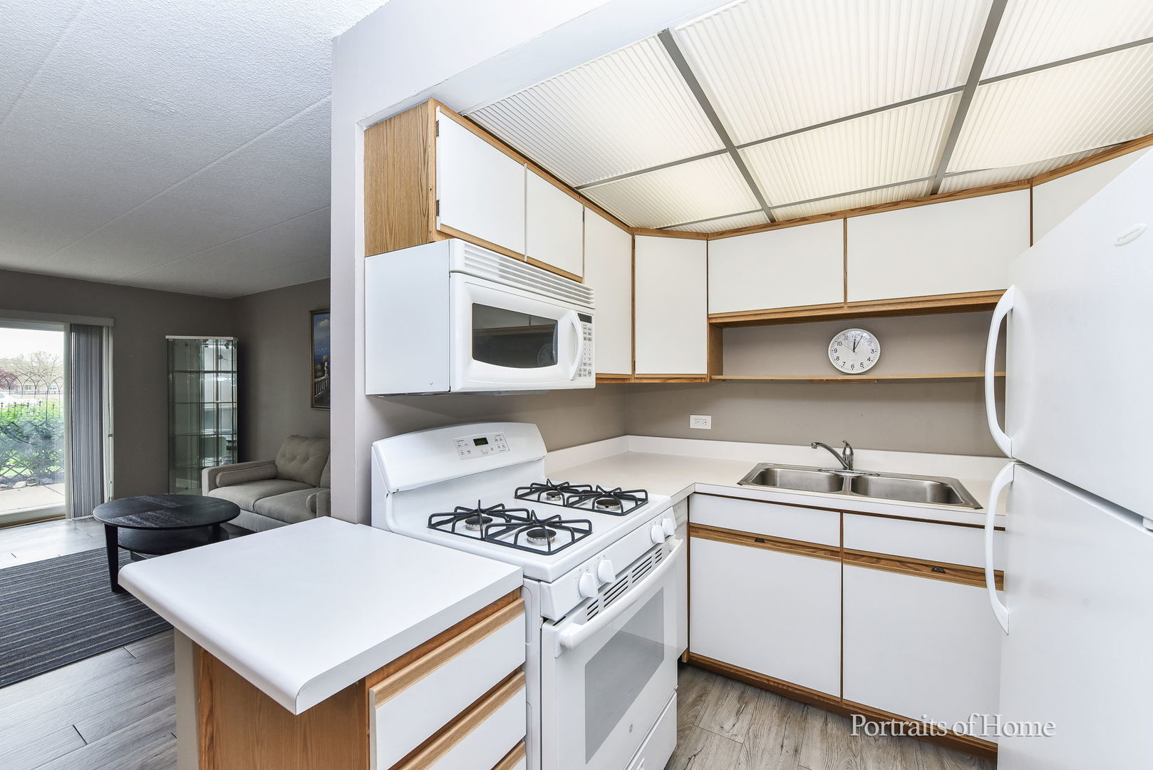 110 West Butterfield Road, Unit 107S Elmhurst, IL 60126 - Photo 5 of 12 a kitchen with a stove and a microwave