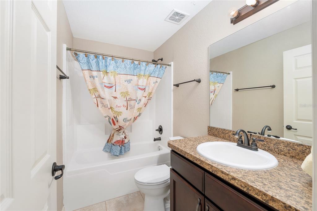 2 Hemlock Loop Drive Ocala, FL 34472 - Photo 23 of 28 a bathroom with a granite countertop sink a toilet and a mirror