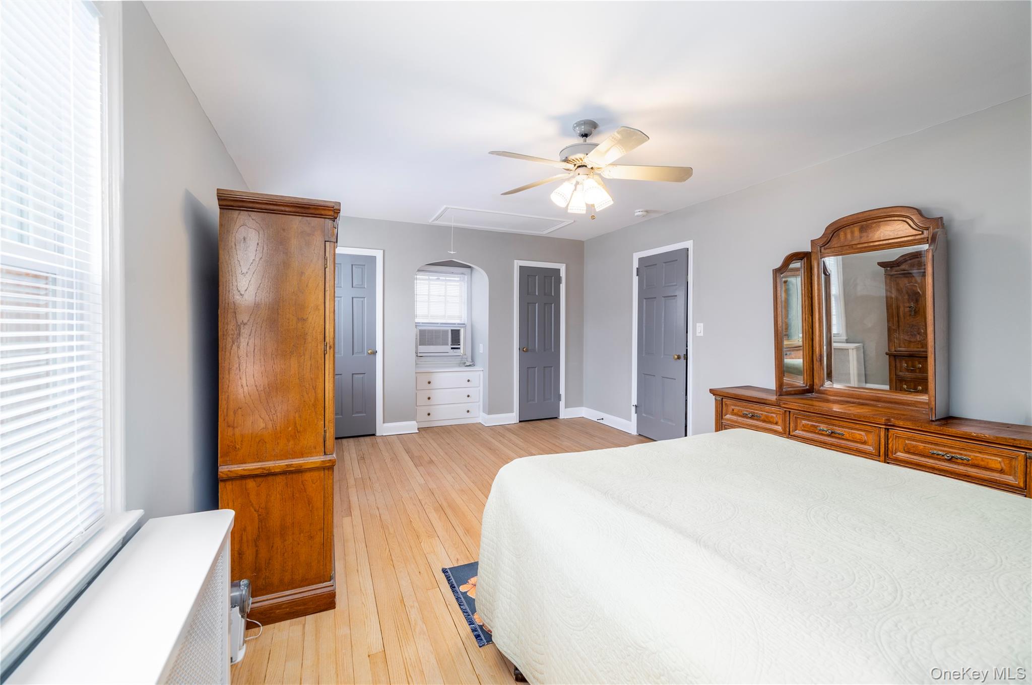 135 Chestnut Street Lynbrook, NY 11563 - Photo 11 of 18 a bedroom with a bed and a chandelier