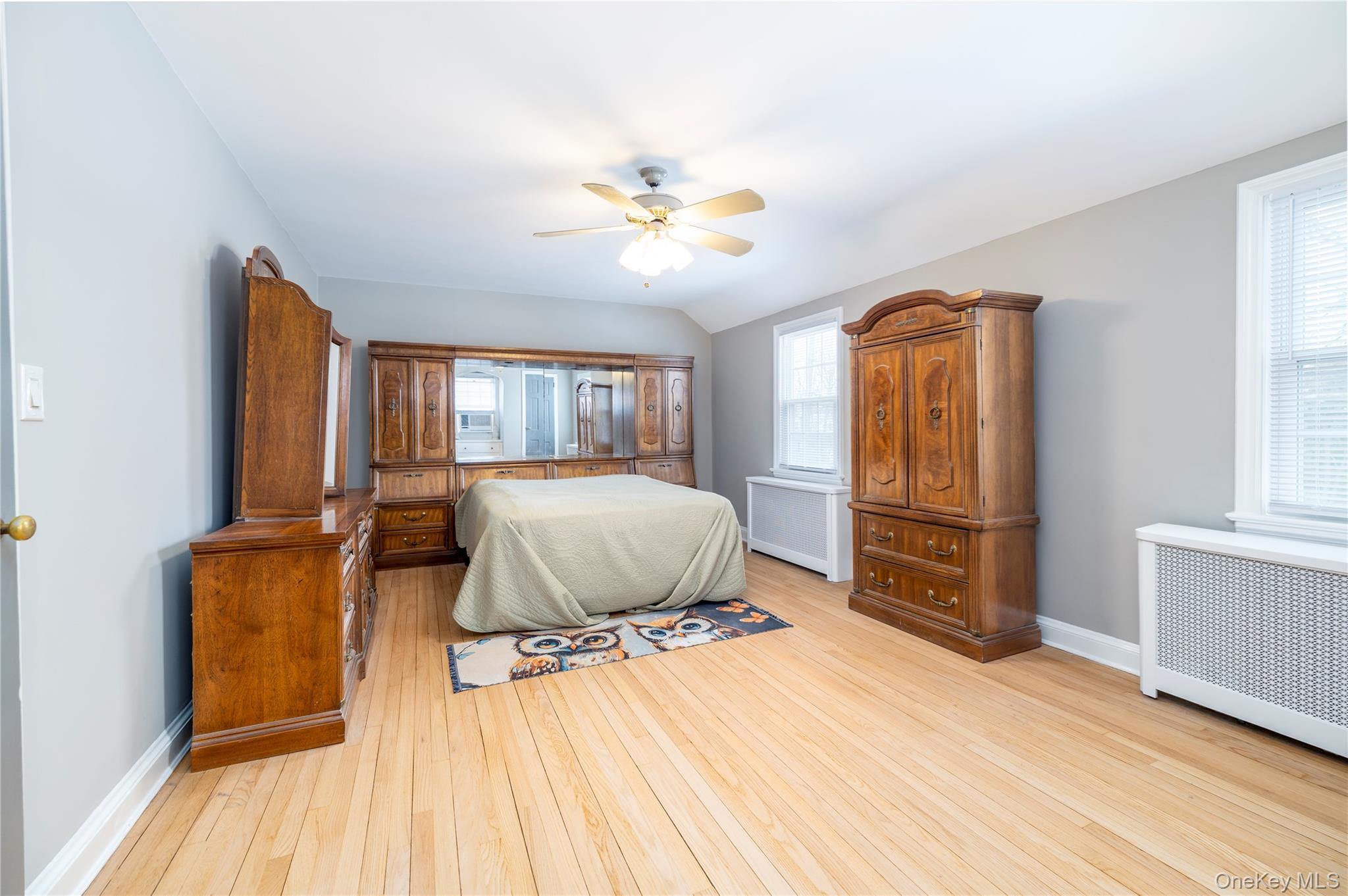 135 Chestnut Street Lynbrook, NY 11563 - Photo 12 of 18 a bedroom with a bed and wooden floor