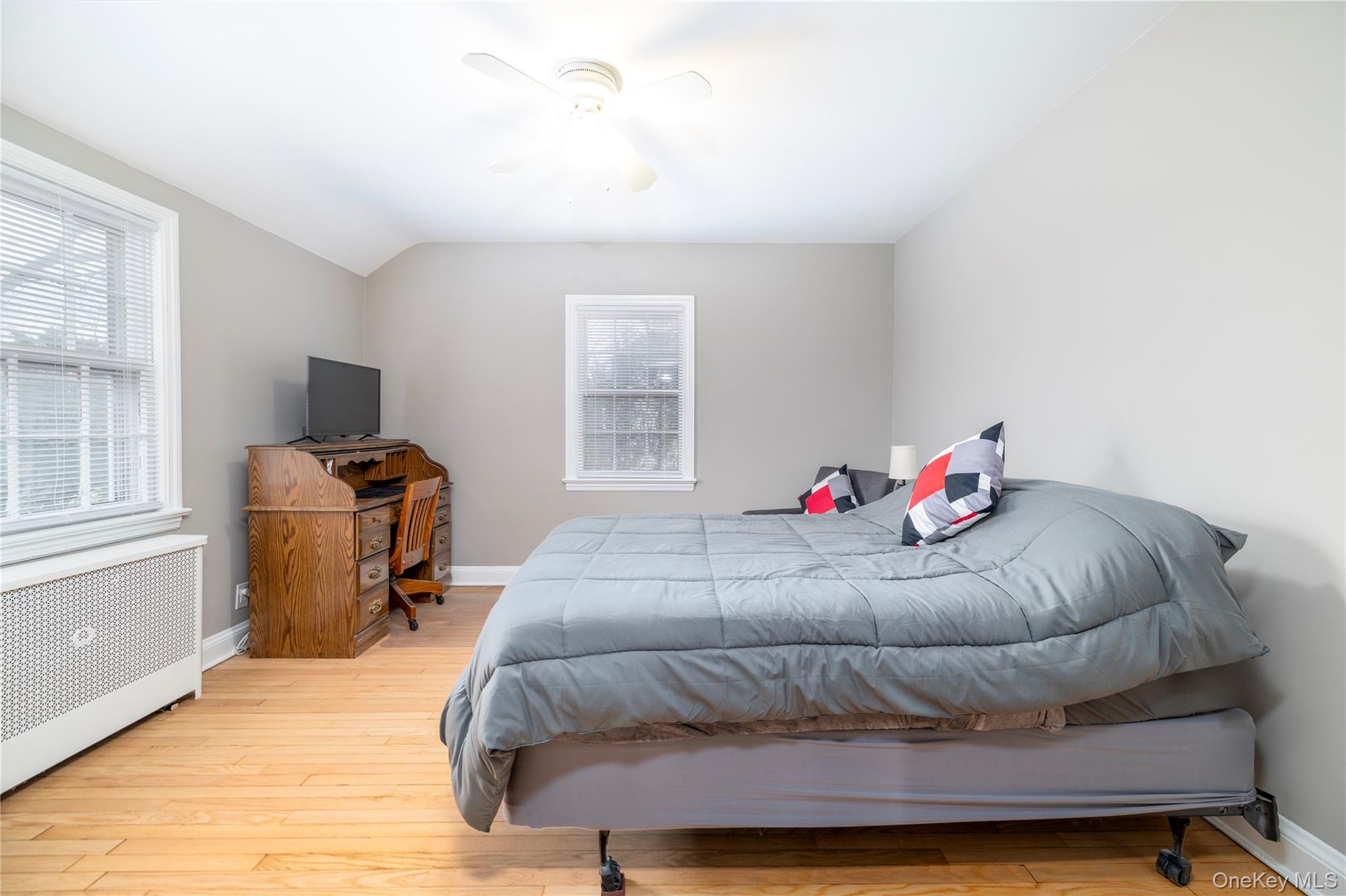 135 Chestnut Street Lynbrook, NY 11563 - Photo 15 of 18 a bedroom with a bed and wooden floor