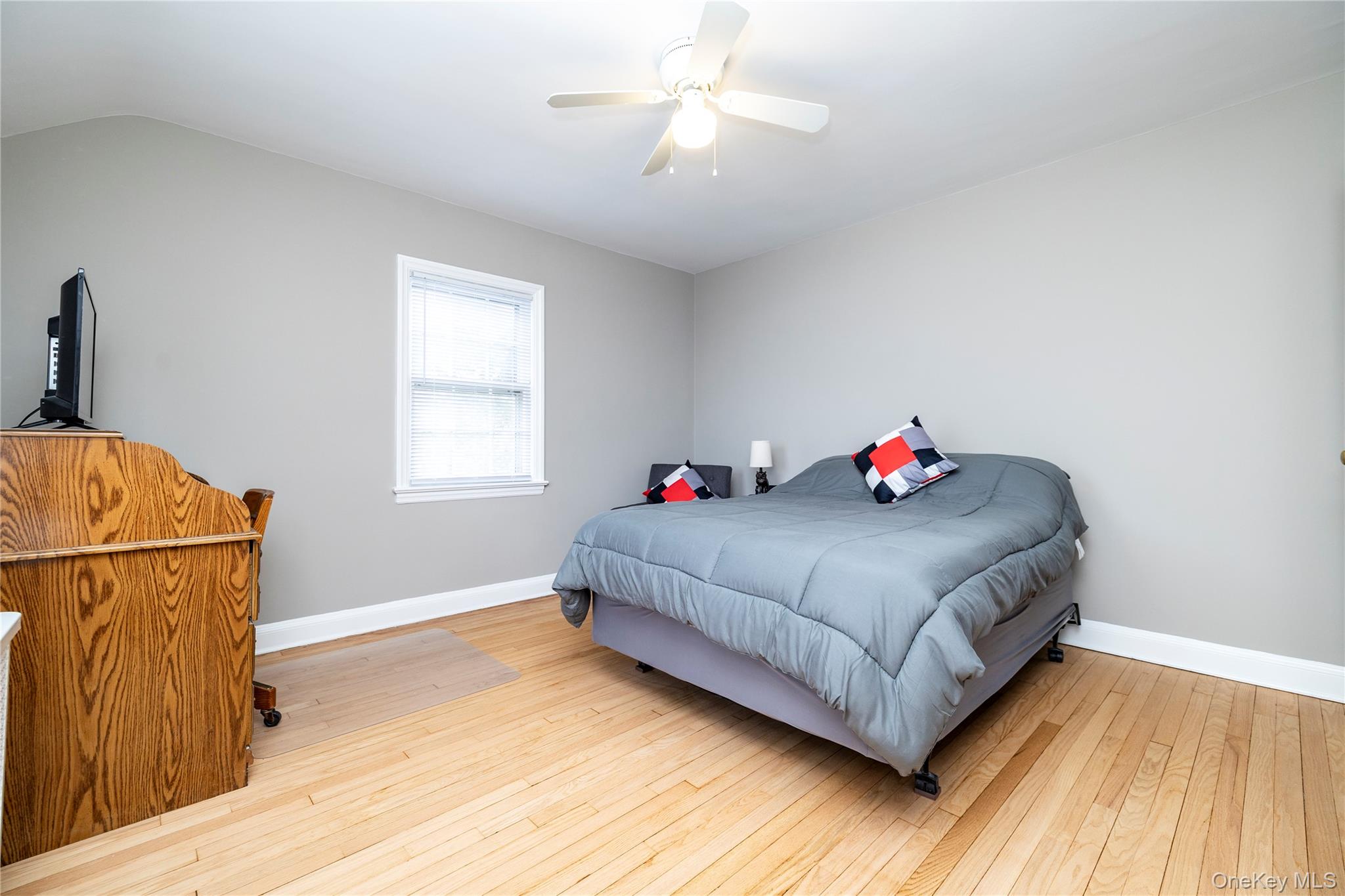135 Chestnut Street Lynbrook, NY 11563 - Photo 16 of 18 a bedroom with a bed and a dresser