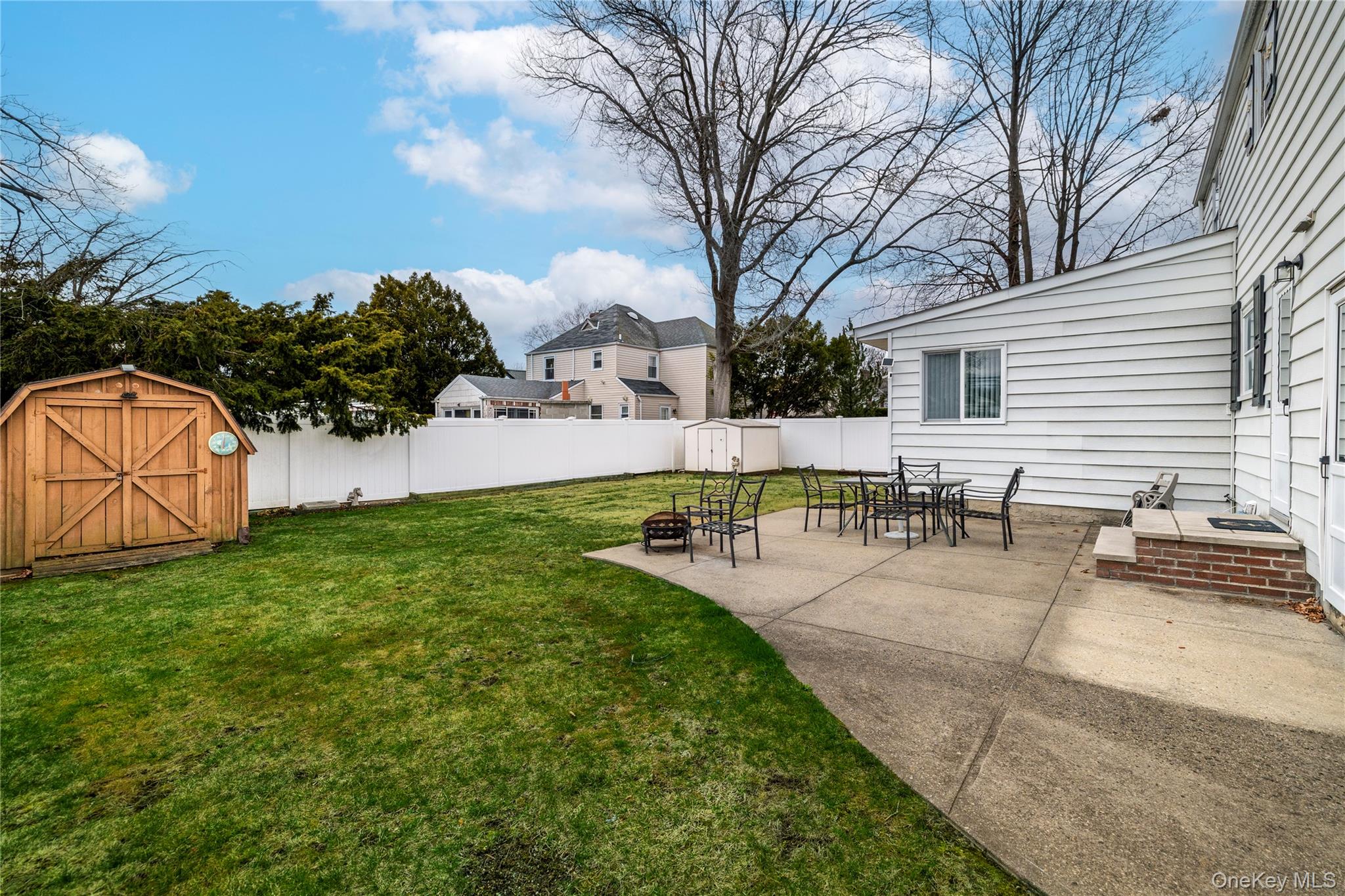135 Chestnut Street Lynbrook, NY 11563 - Photo 17 of 18 a view of a backyard with sitting area