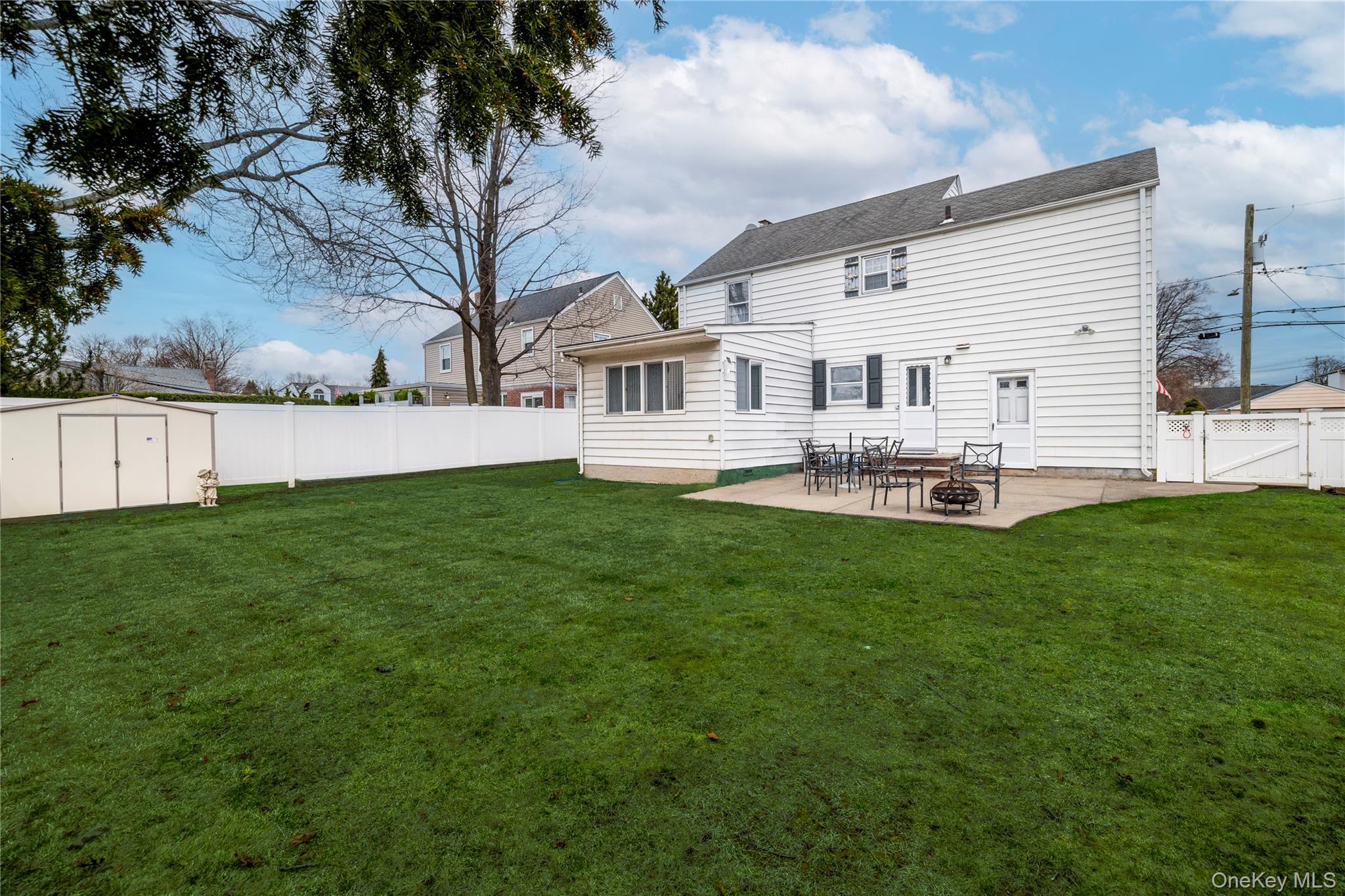 135 Chestnut Street Lynbrook, NY 11563 - Photo 18 of 18 a front view of house with yard and outdoor seating