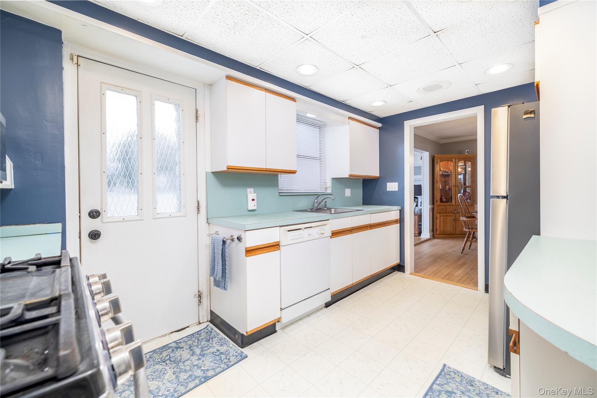 135 Chestnut Street Lynbrook, NY 11563 - Photo 8 of 18 a large white kitchen with a large window