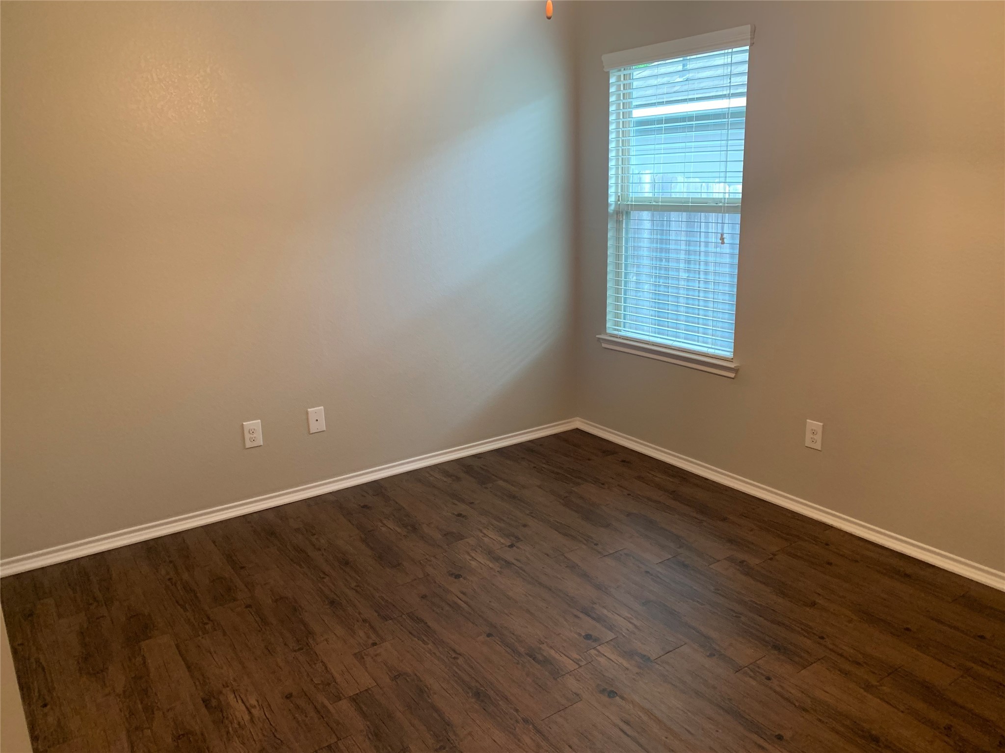 1929 Briar Grove Drive Conroe, TX 77301 - Photo 10 of 17 an empty room with wooden floor and windows