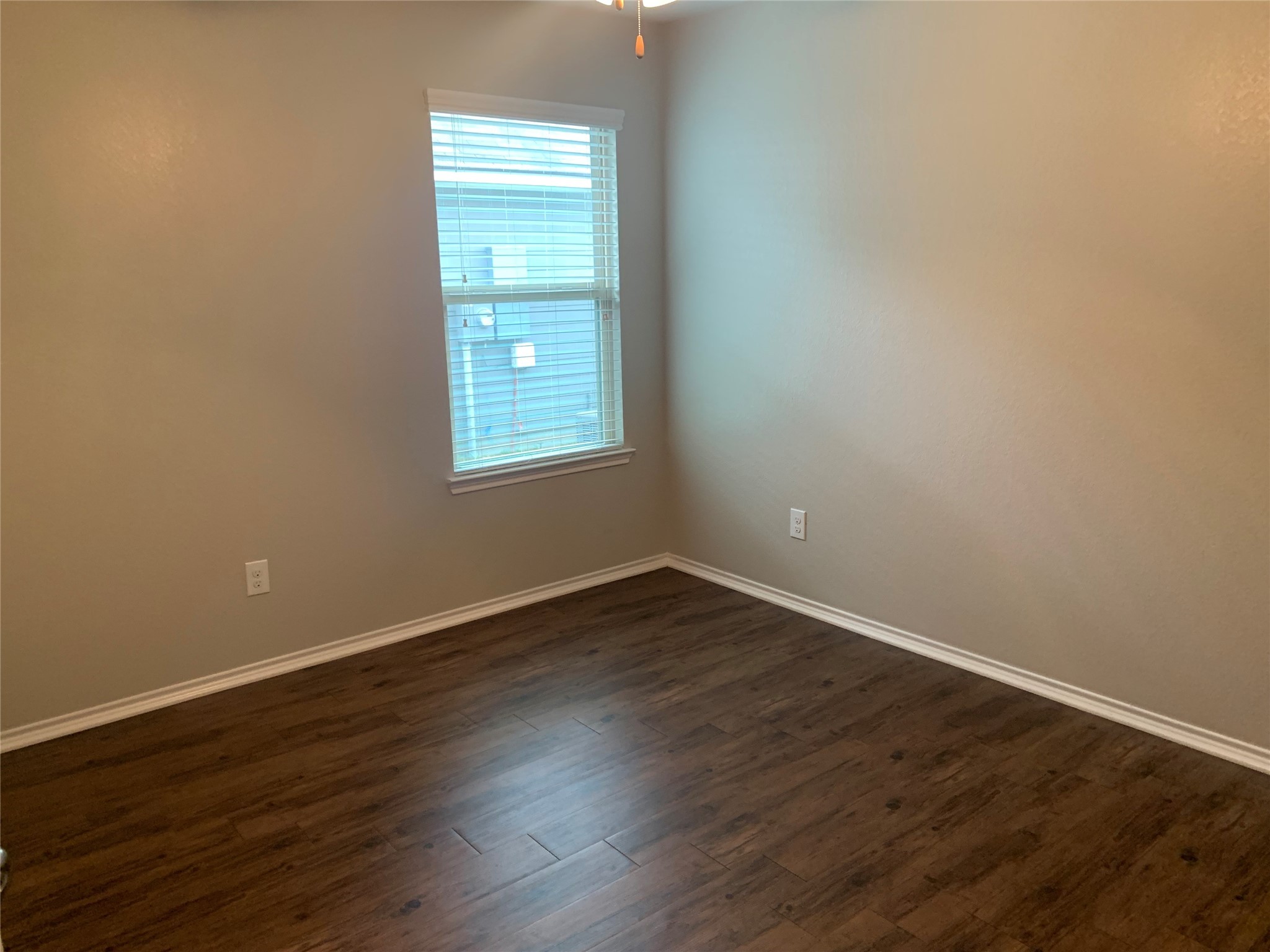 1929 Briar Grove Drive Conroe, TX 77301 - Photo 11 of 17 an empty room with wooden floor and windows
