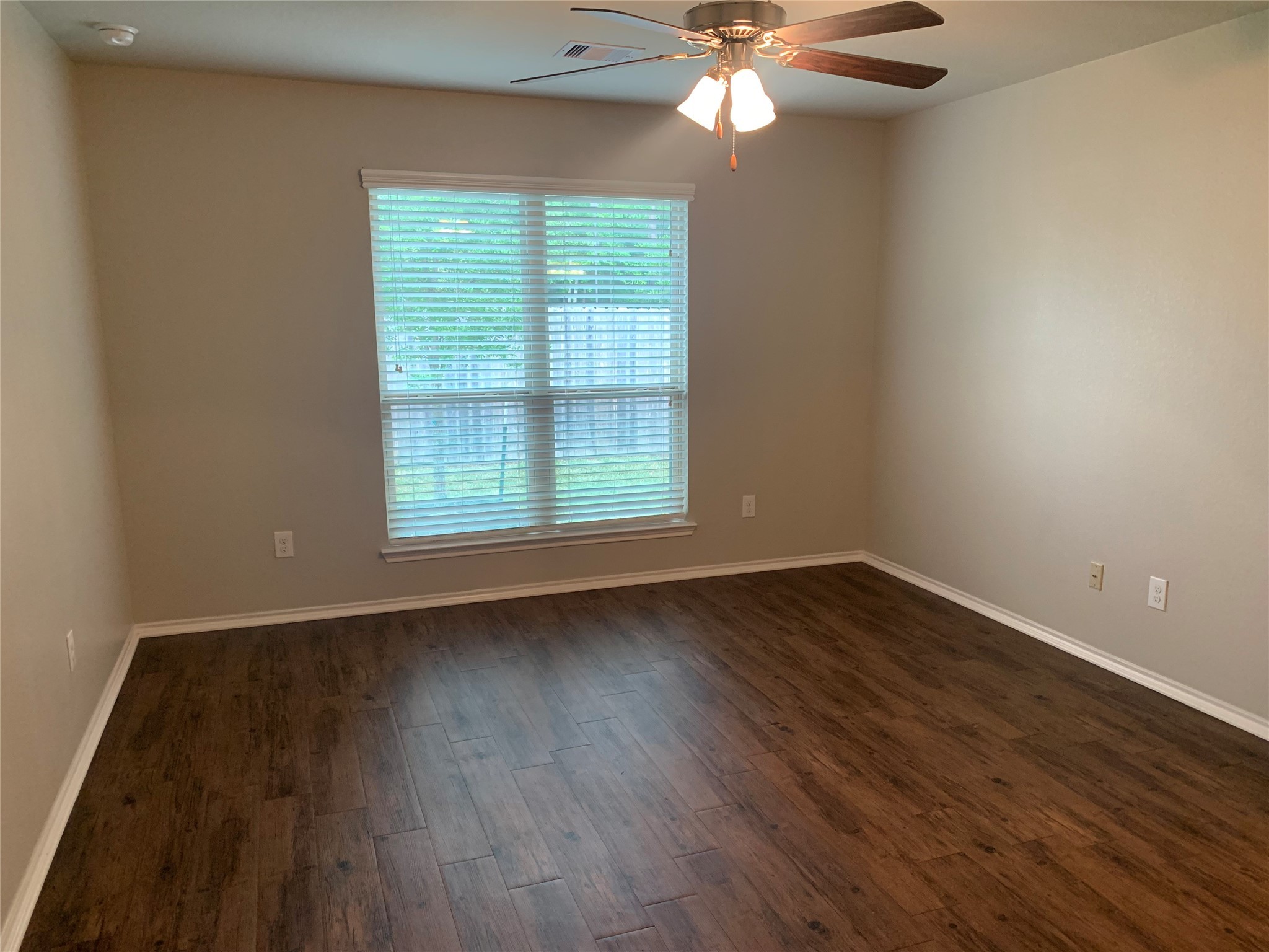 1929 Briar Grove Drive Conroe, TX 77301 - Photo 12 of 17 a view of an empty room with wooden floor and a window