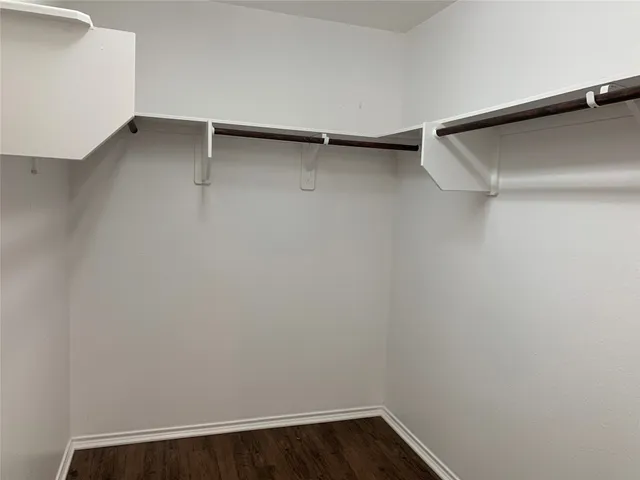 a bathroom with a granite countertop sink a mirror and a bathtub