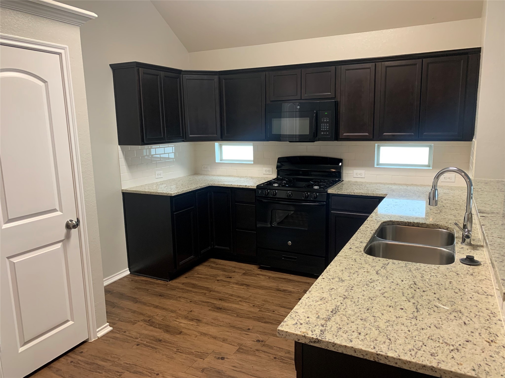 1929 Briar Grove Drive Conroe, TX 77301 - Photo 4 of 17 a kitchen with wooden cabinets and a sink