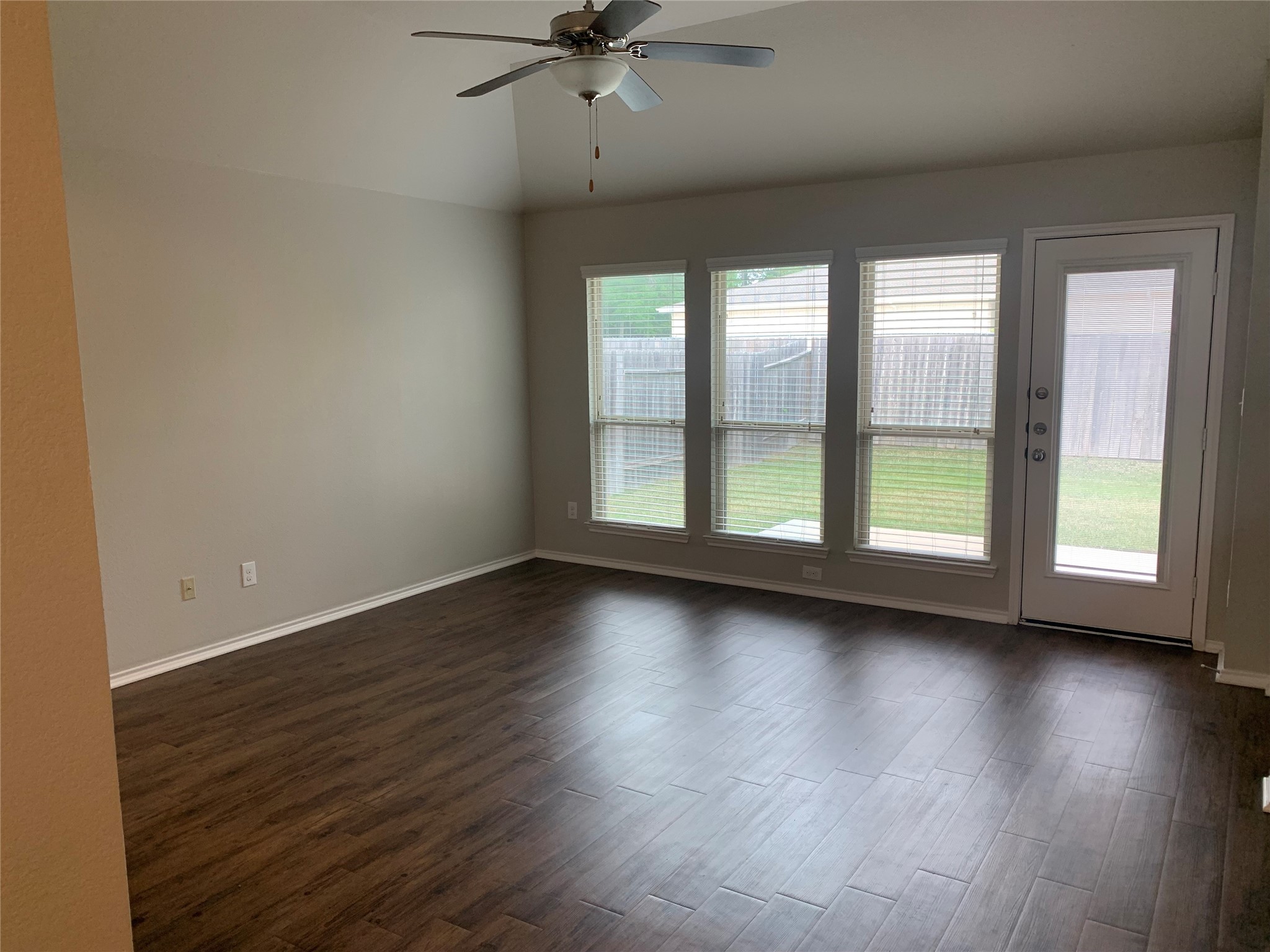 1929 Briar Grove Drive Conroe, TX 77301 - Photo 5 of 17 an empty room with wooden floor and windows