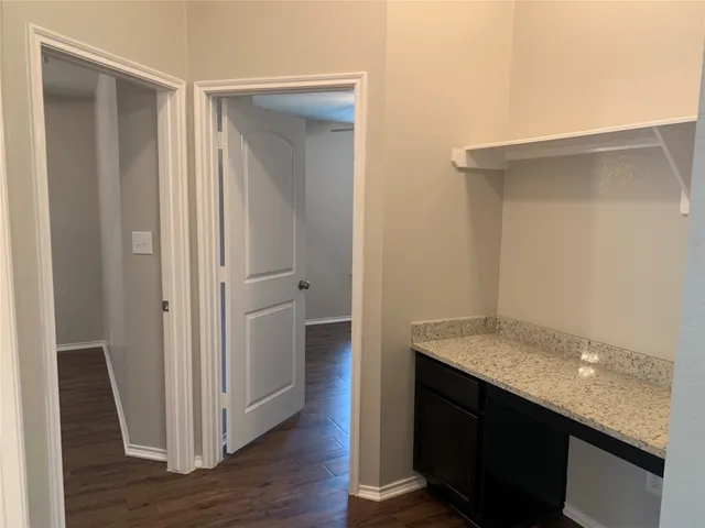 a view of a room with wooden floor
