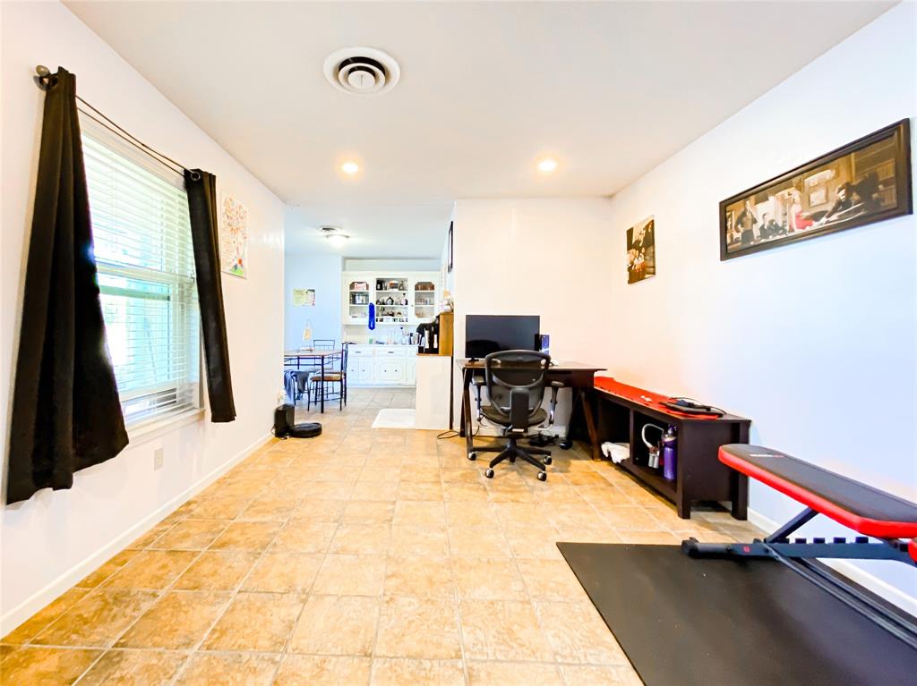 4301 Caprock Road Abilene, TX 79606 - Photo 12 of 29 Spacious interior featuring tile flooring, white walls, recessed lighting, and a window with blinds