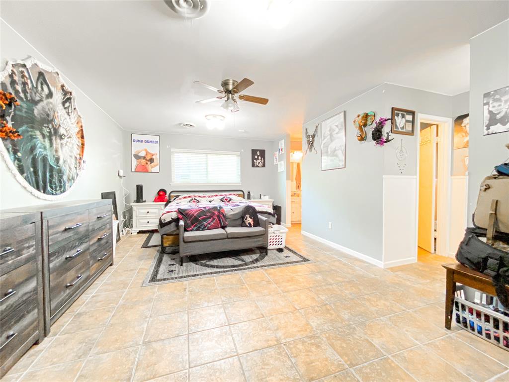 4301 Caprock Road Abilene, TX 79606 - Photo 17 of 29 Spacious interior room featuring neutral wall tones, tile flooring, and a ceiling fan