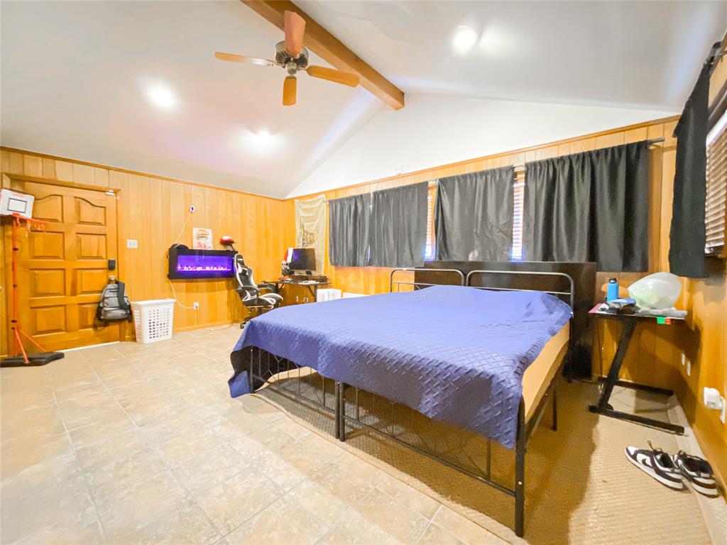 4301 Caprock Road Abilene, TX 79606 - Photo 21 of 29 Vaulted ceiling with exposed wood beam and ceiling fan