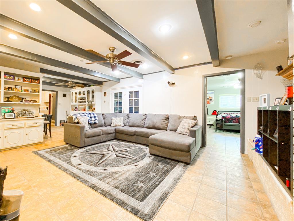 4301 Caprock Road Abilene, TX 79606 - Photo 5 of 29 Spacious living area featuring exposed ceiling beams, recessed lighting, and tile flooring