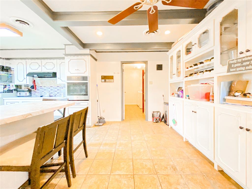 4301 Caprock Road Abilene, TX 79606 - Photo 7 of 29 Kitchen featuring white cabinetry, a built-in oven, tile flooring, and a ceiling fan
