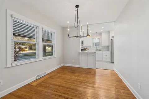 a view of kitchen with wooden floor and window