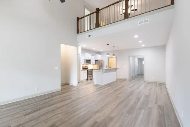 a view of a kitchen with wooden floor