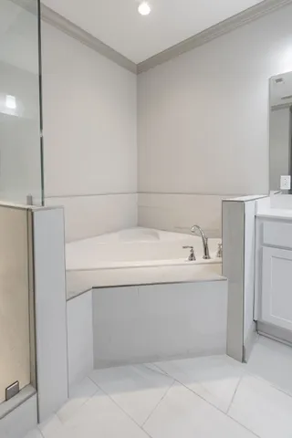 a bathroom with a bathtub and closet