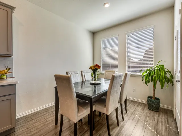 a view of a dining room with furniture and window