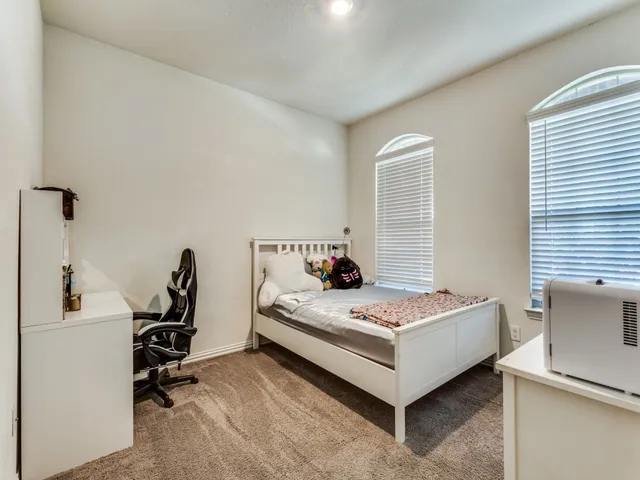 a bedroom with bed and a window